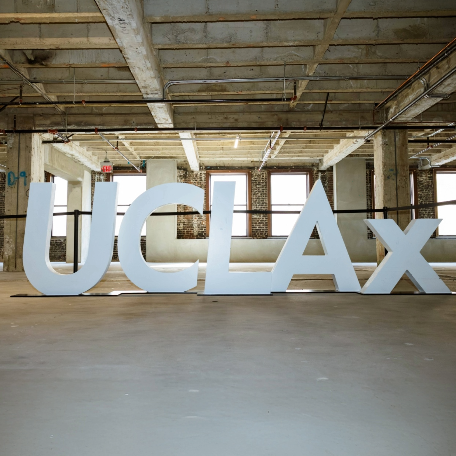 Large physical letters of UCLAx in a sparce building
