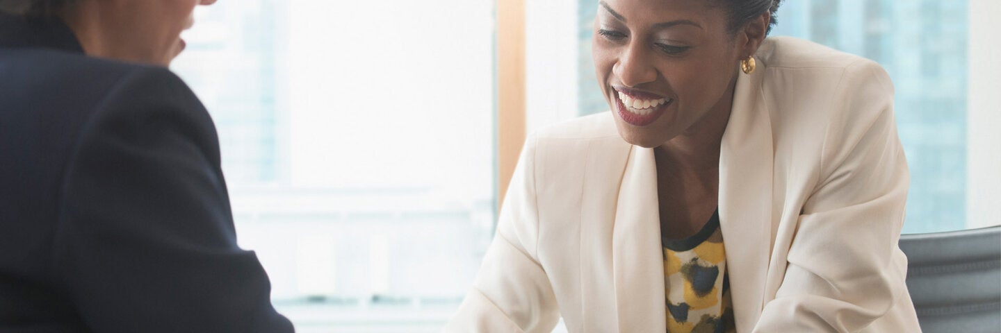HR manager reviewing benefits on tablet with employee
