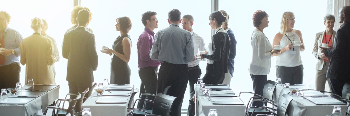 Men and women talking at a human resources workshop.