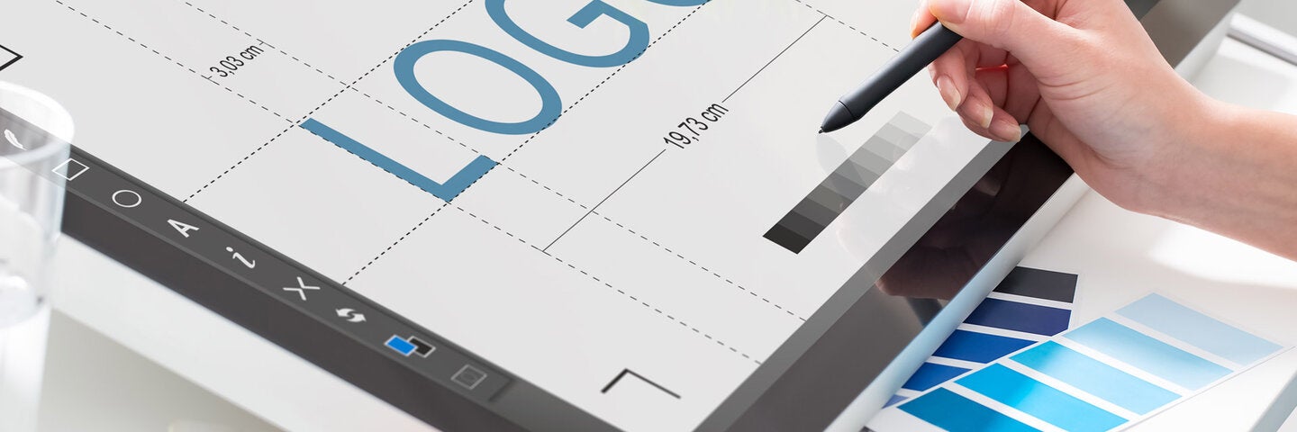 Graphic designer working on logo on computer.