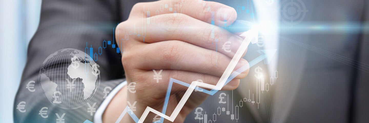 business man hand with stylus pointing at computer, superimposed financial graphics