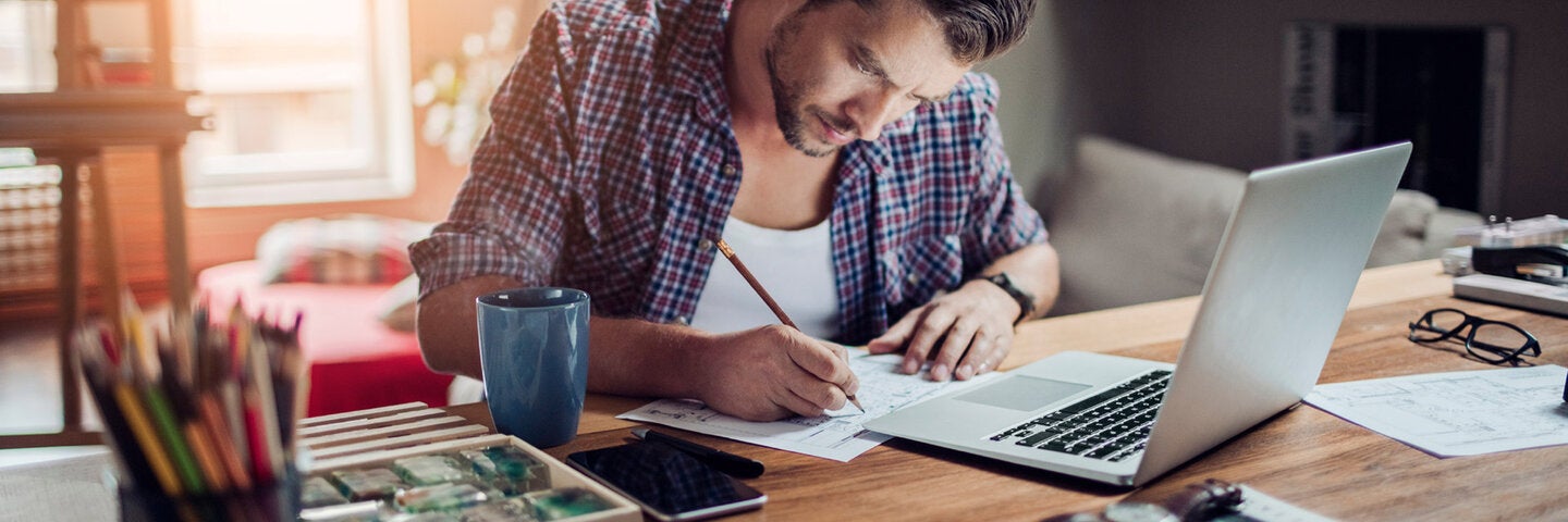 Man writing at a desk