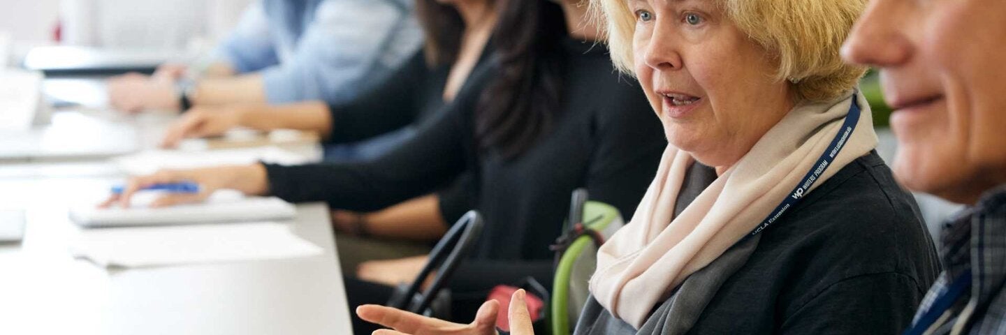 Writers sitting at a table discussing plot points.