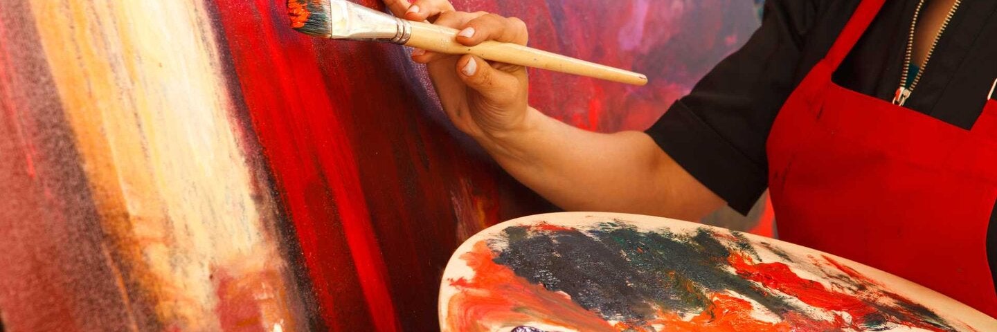 Woman painting on a canvas