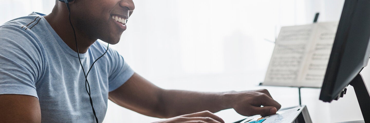 Musician writing music on computer