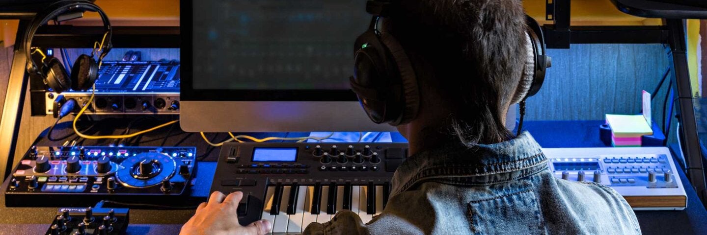 Man producing music in home studio.