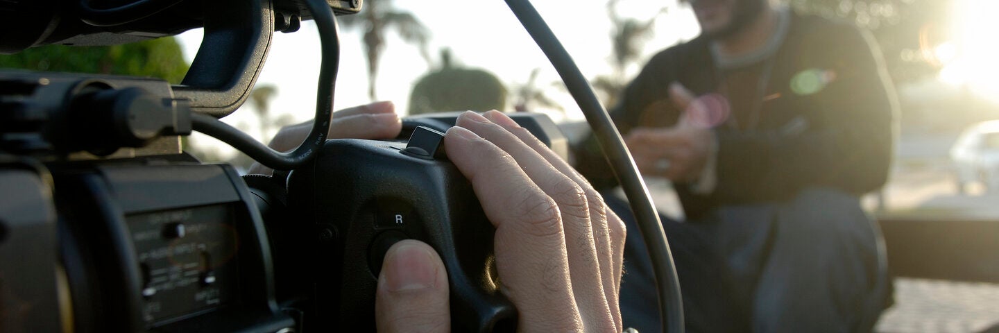 Cameraman Filming a man speaking In daylight