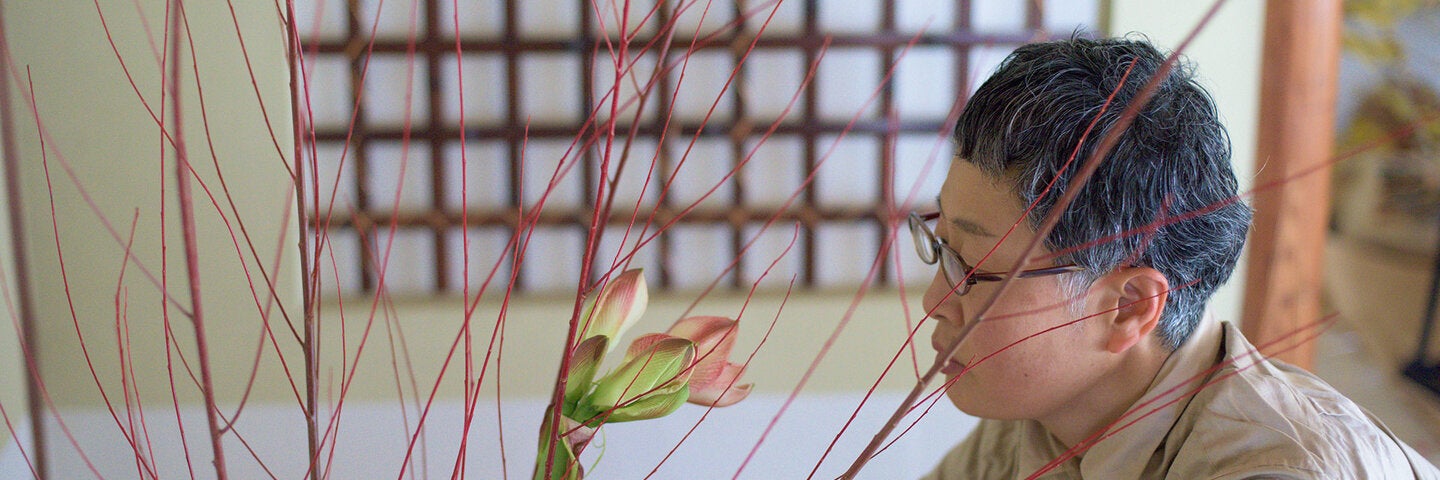 woman studying flower