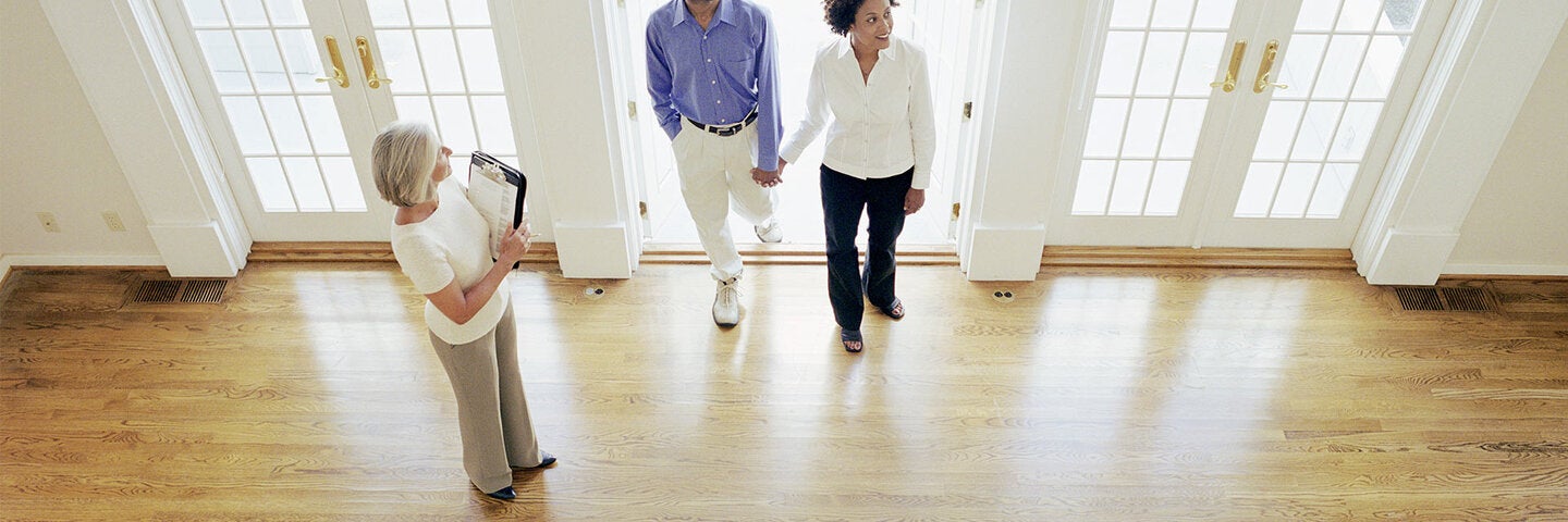 Married couple being showed house by female realtor