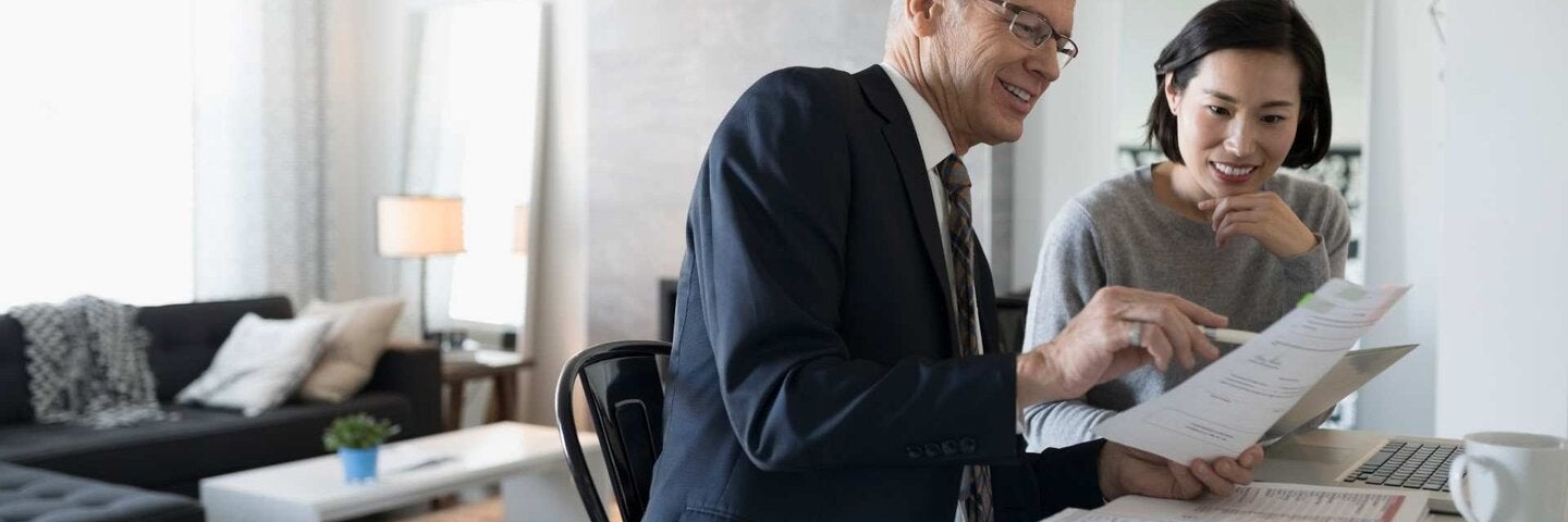 Woman planning investments with financial officer