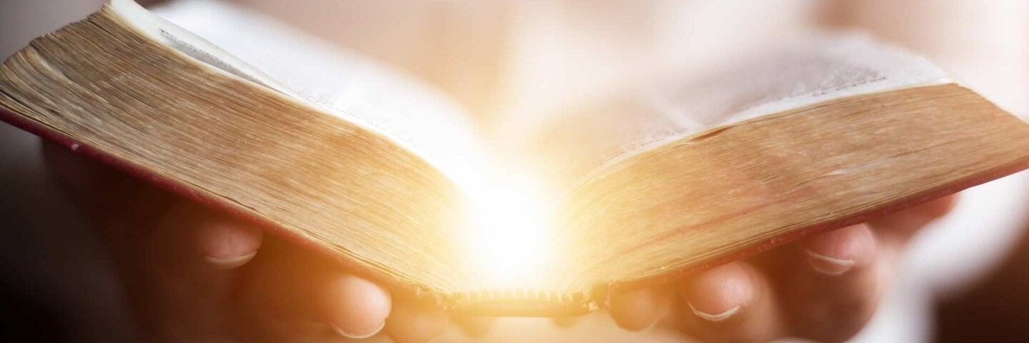 Woman reading holy bible.