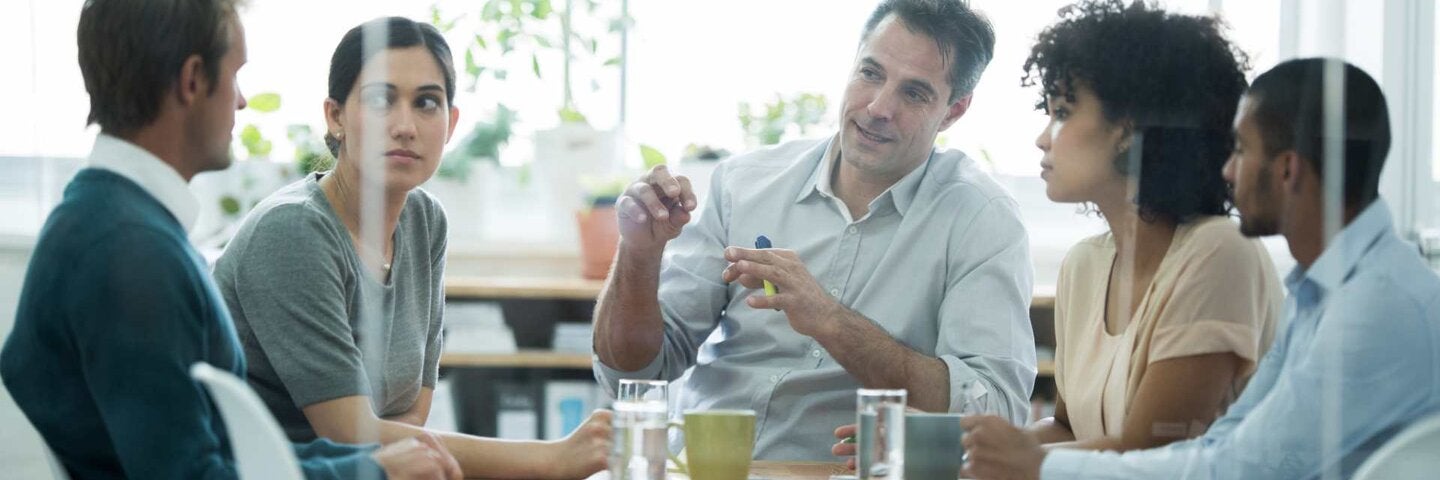 conference room with a group of business professionals sitting around the table