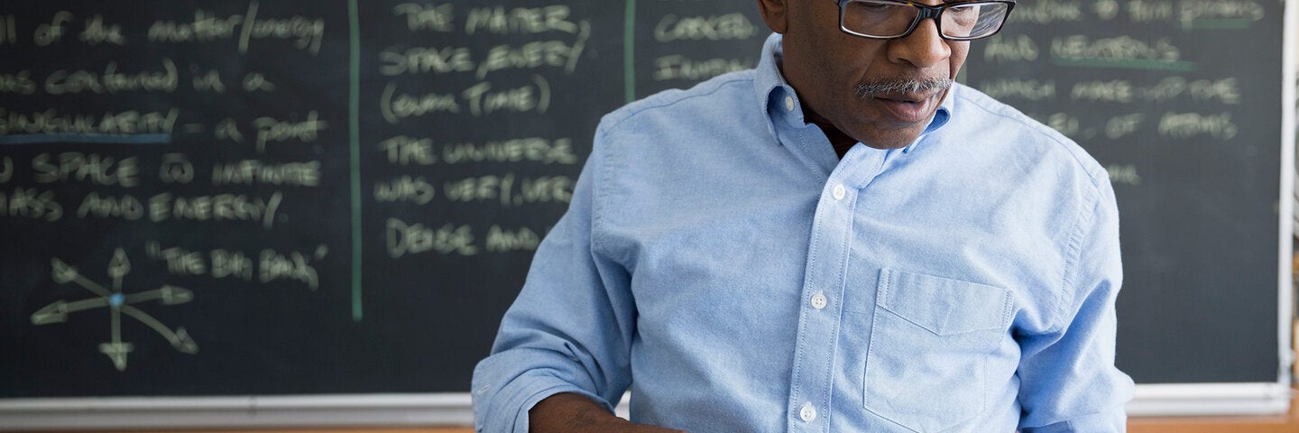 teacher reviewing lesson plan on tablet