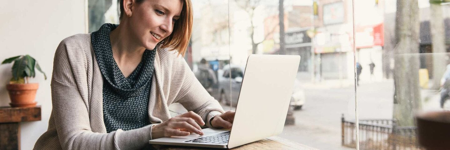 woman with laptop at coffee shop