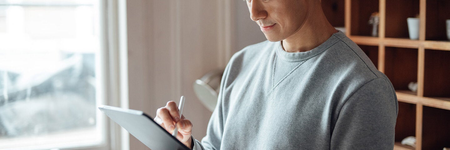 young man using a stylus and tablet