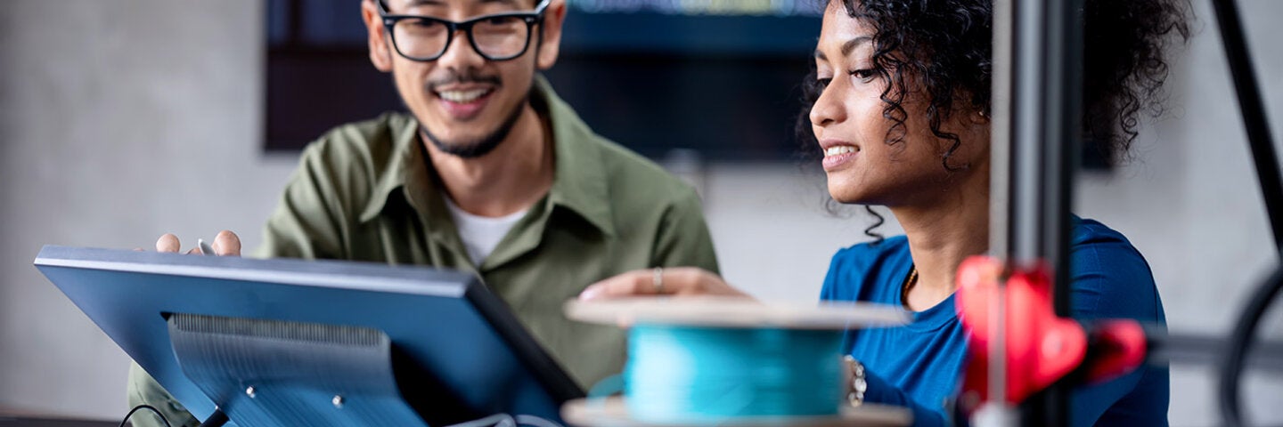man and woman looking at a screen