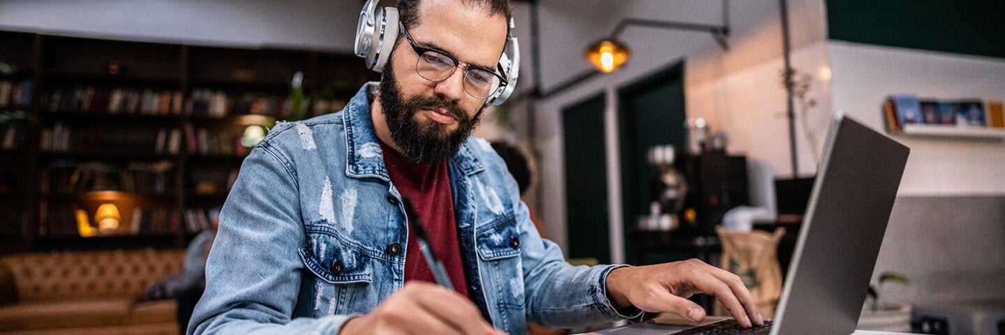 writer working on laptop and notepad