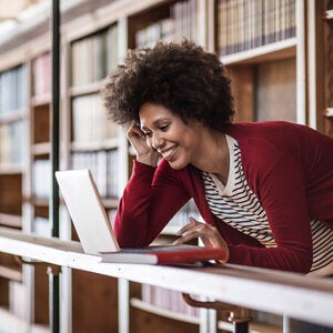 Young teacher looking at laptop