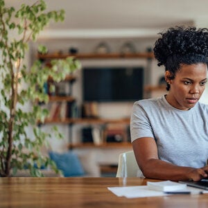 young man typing on laptop