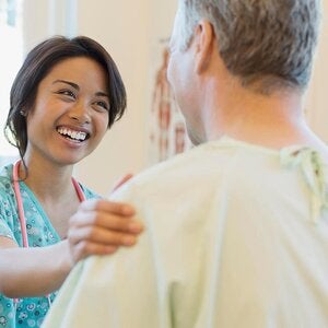female medical assistant smiling at patient